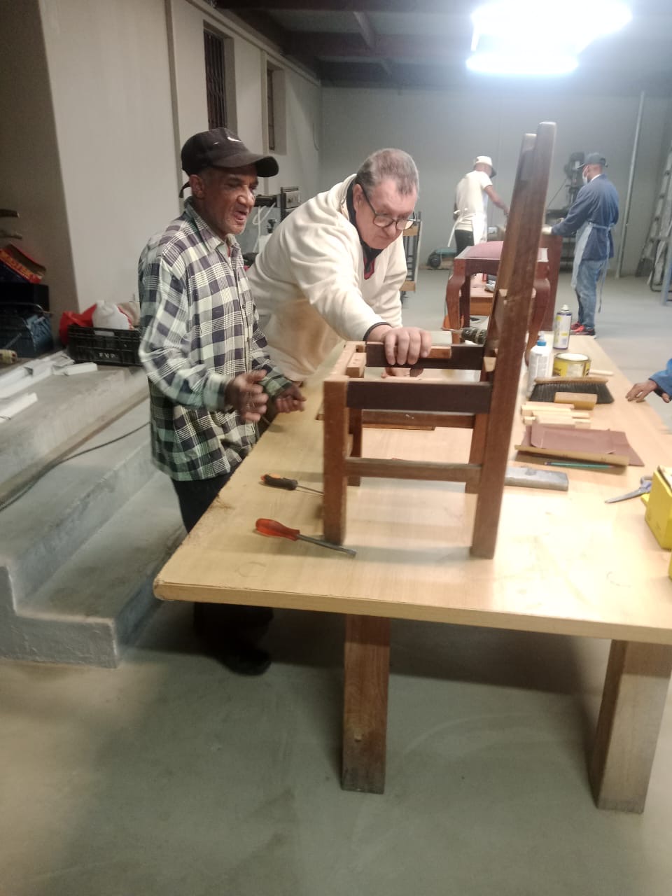 Participants learning woodworking skills