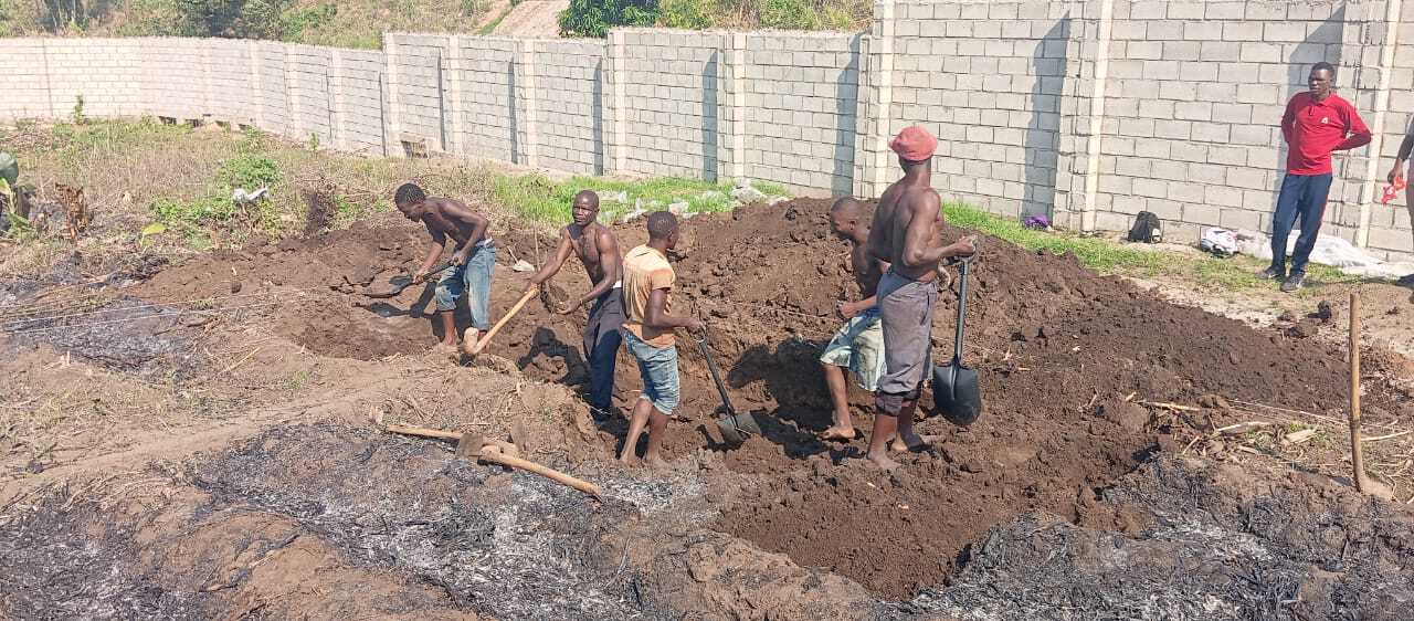 Workers digging a new fish farm pond in Malawi