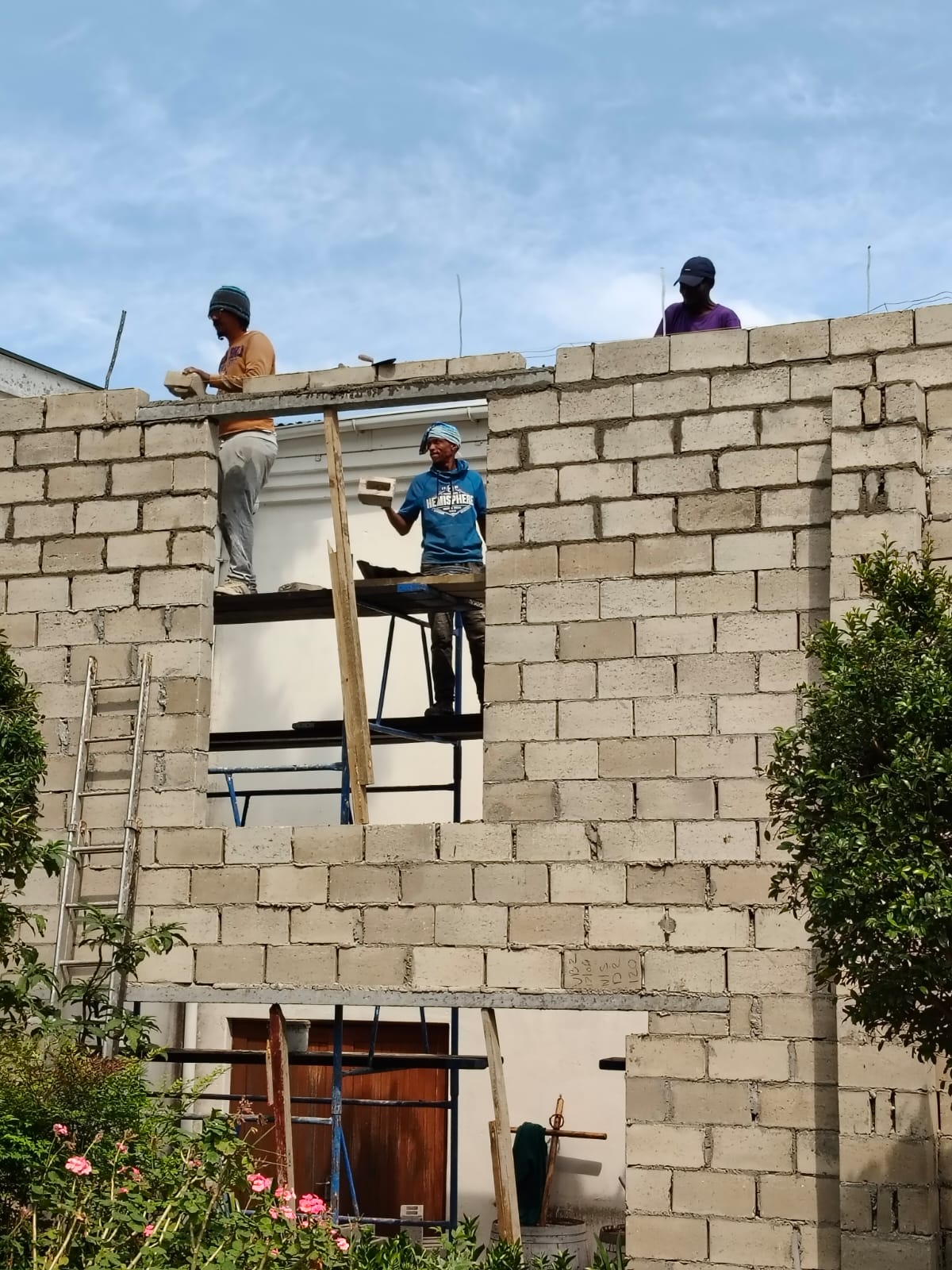 Builders raising the walls of the Franschhoek community sewing centre