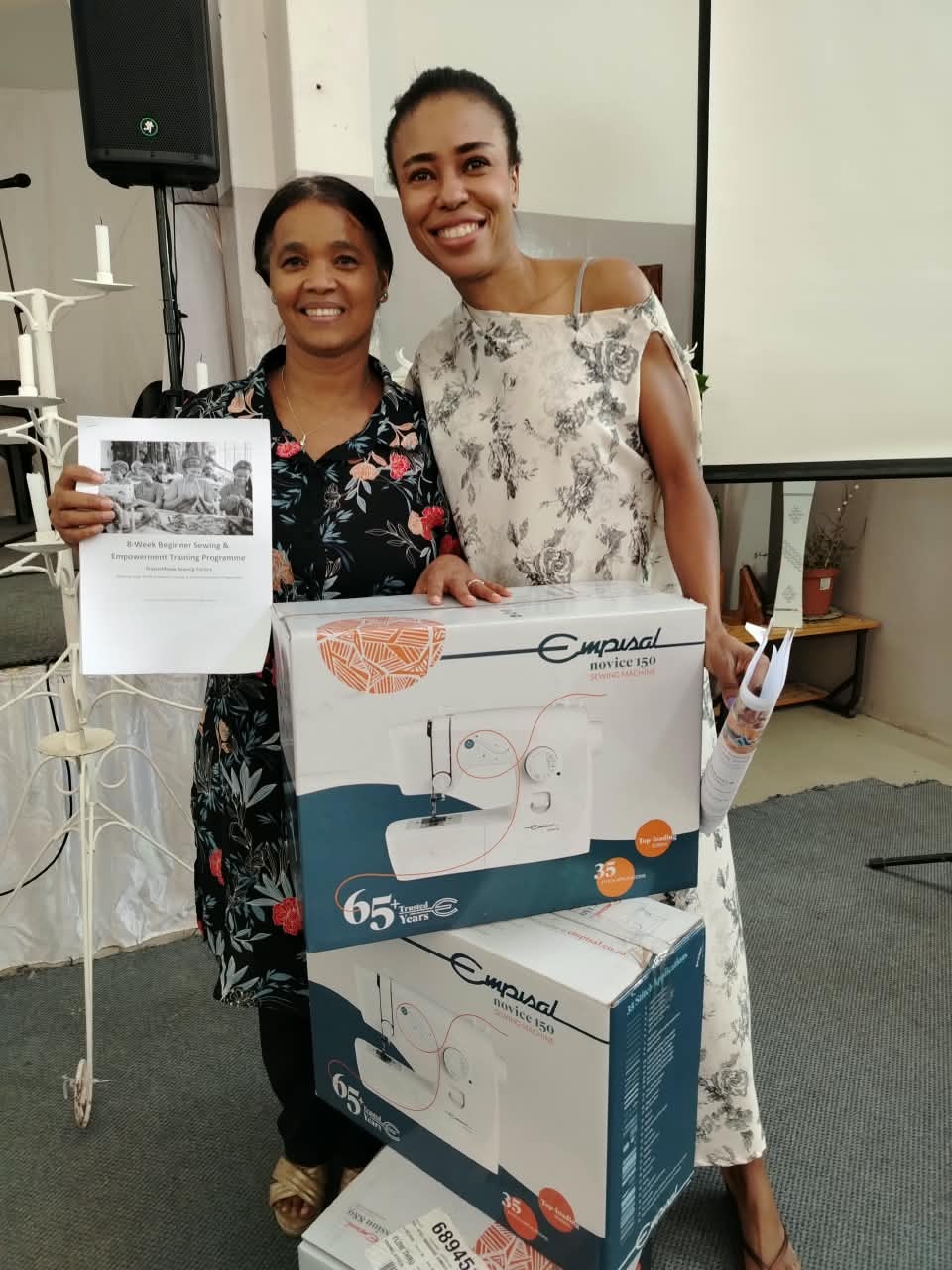 Participant with the 8-week training programme booklet and a new sewing machine